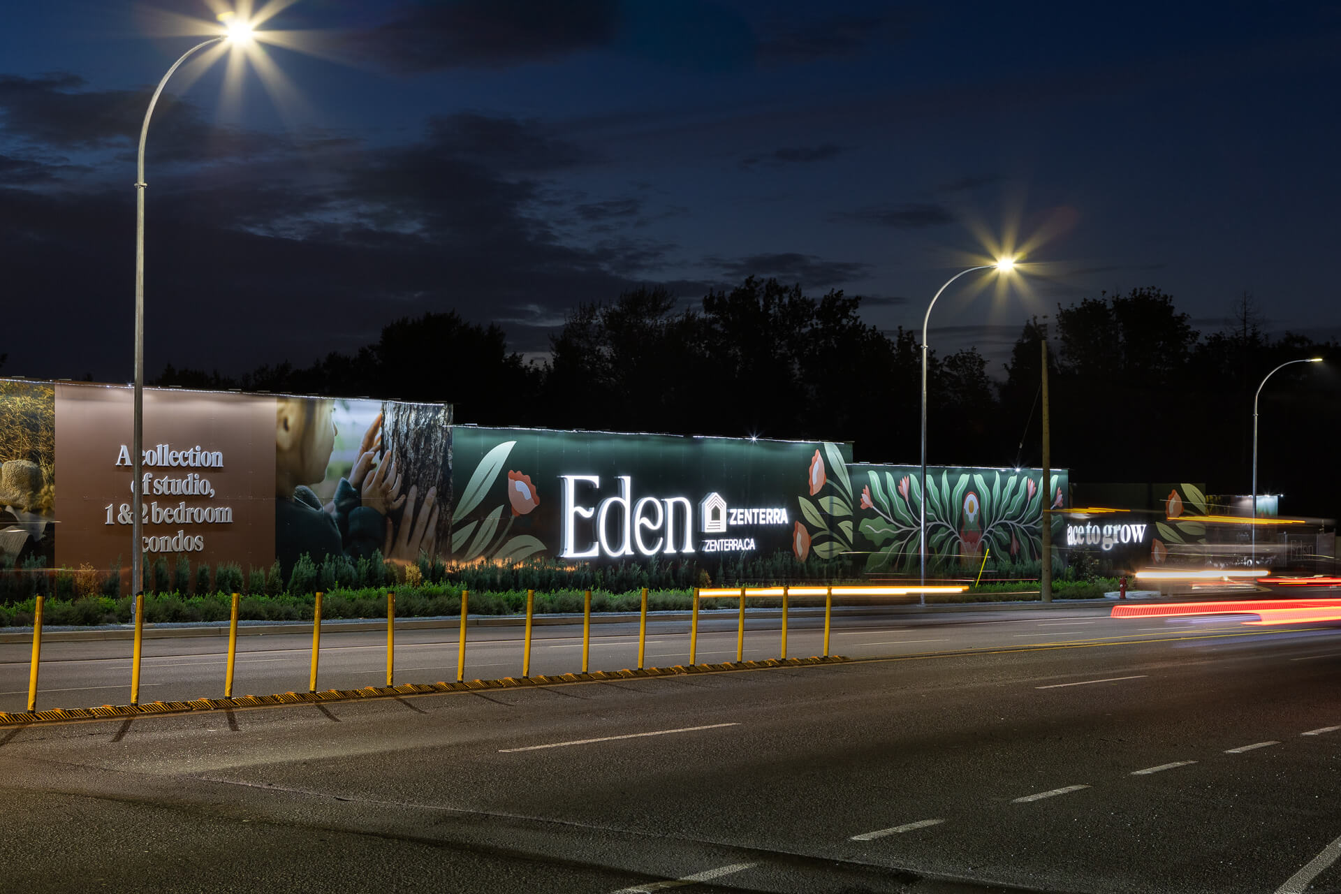 Nighttime Eden campaign signage along the street frontage.