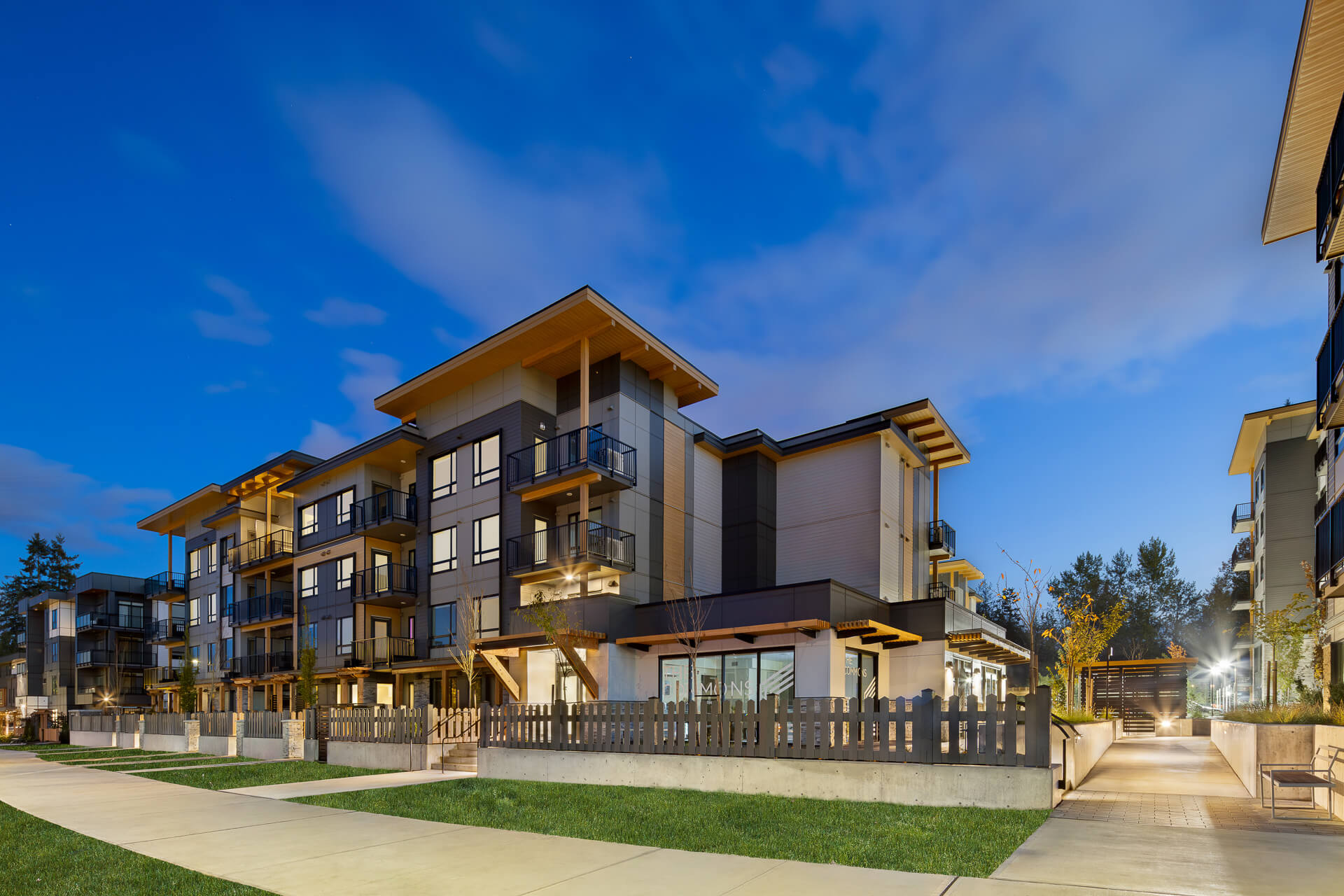 Evening exterior view of The Commons condo community.